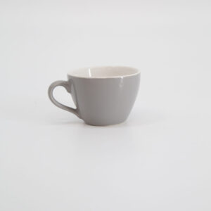 Tazza singola in ceramica di colore grigio chiaro con interno bianco crema e manico, posizionata su sfondo bianco.