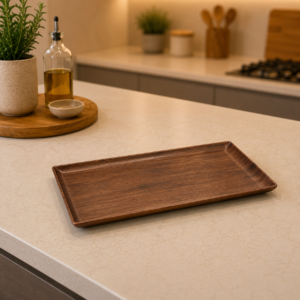 Vassoio rettangolare in legno scuro con bordi rialzati, posizionato su un bancone da cucina chiaro in un ambiente moderno.