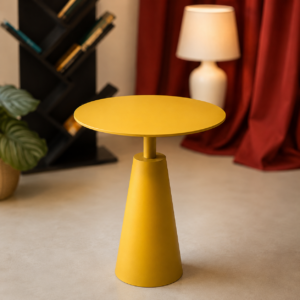 Tavolino di servizio giallo opaco con piano circolare e base conica, posizionato su un pavimento chiaro in un ambiente interno.