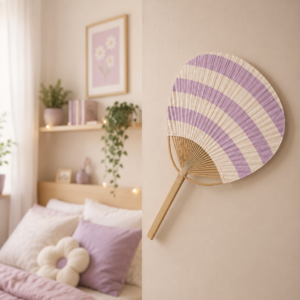 Ventaglio giapponese Uchiwa decorativo con strisce orizzontali viola chiaro e crema, appeso su una parete chiara.
